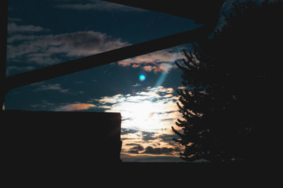 Silhouette trees seen through car window