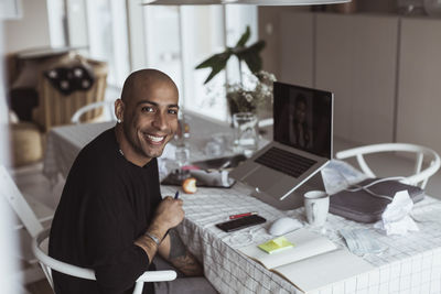 Portrait of smiling man sitting at table