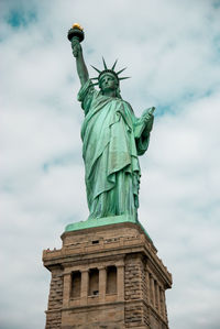 Low angle view of statue against cloudy sky