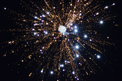 Low angle view of illuminated christmas tree against sky at night