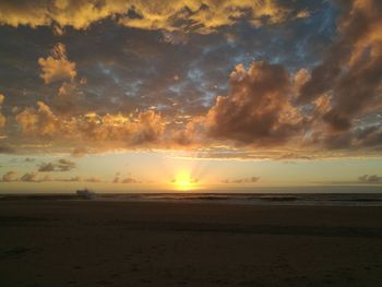 Scenic view of beach against sky during sunset