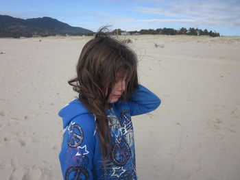 Sad teenage girl crying at beach