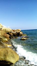 Scenic view of sea against clear blue sky