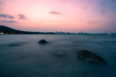 Scenic view of sea against sky at sunset