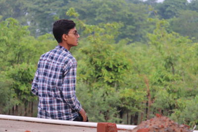 Side view of a young man looking away