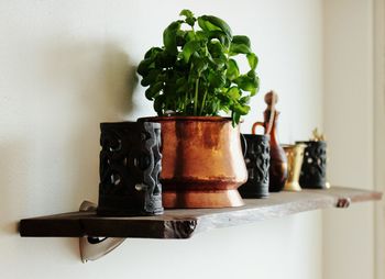 Close-up of decors on shelf over wall at home