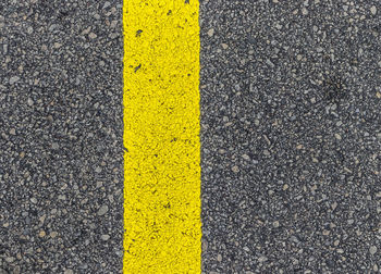 High angle view of yellow road sign on street