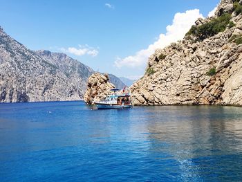 Scenic view of sea and mountains against sky