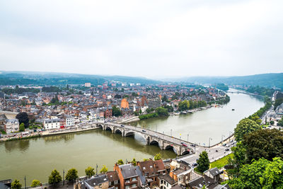 High angle view of river amidst buildings in city against sky