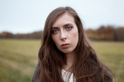 Portrait of beautiful young woman in field