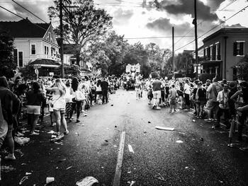 Crowd on street against sky