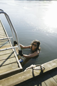 Woman swimming in cold lake