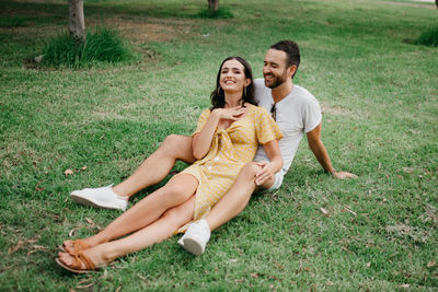 Happy couple relaxing on grass