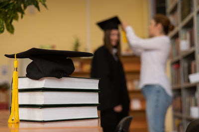 Rear view of woman wearing graduation gown