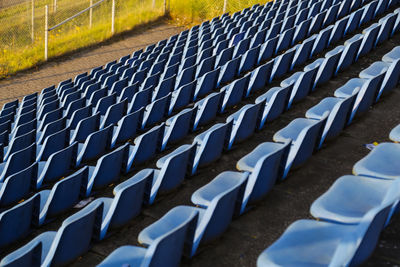 High angle view of blue empty chairs at stadium