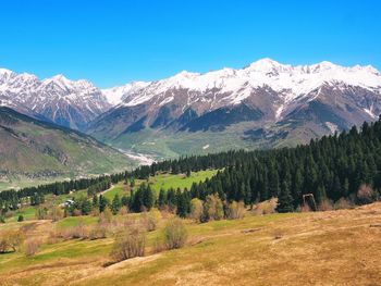 Scenic view of mountains against clear blue sky