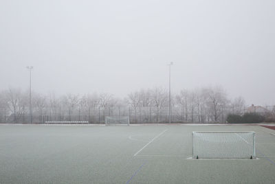 View of soccer field against sky during foggy weather