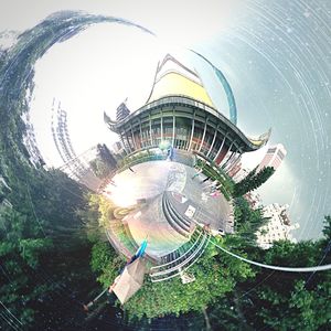 Digital composite image of ferris wheel and buildings against sky