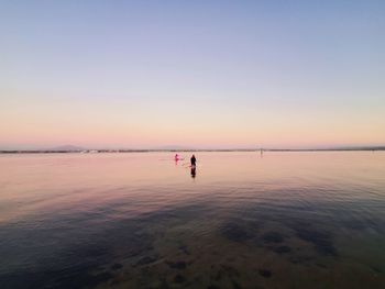 Scenic view of sea against clear sky during sunset