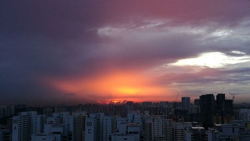 Cityscape against cloudy sky