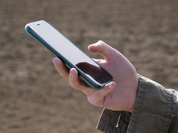 Midsection of person using mobile phone