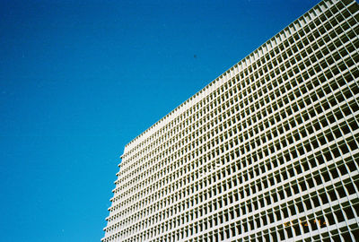 Low angle view of modern building against blue sky