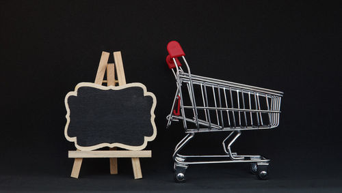 Empty chairs against black background