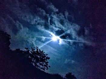 Low angle view of silhouette trees against sky at night