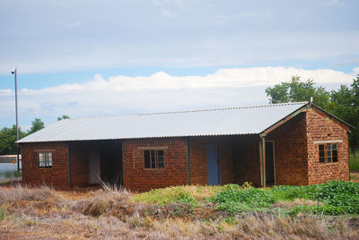 House on field against sky