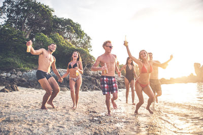 Friends enjoying at beach during summer