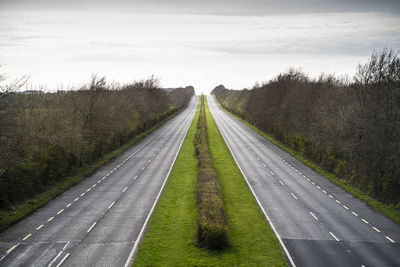 Empty road along countryside landscape