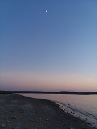 Scenic view of sea against clear sky at sunset