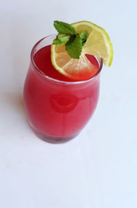 Close-up of red drink over white background