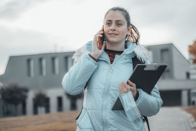 Portrait of young woman using mobile phone