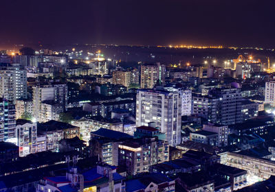 High angle view of illuminated buildings in city at night