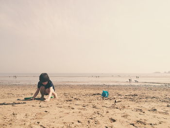 People on beach against sky