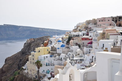 Townscape by sea against clear sky