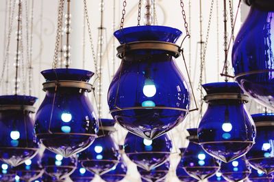 Illuminated blue lanterns hanging from ceiling