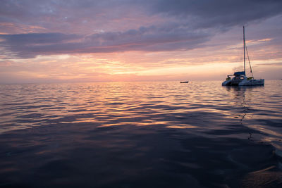 Boat in sea at sunset