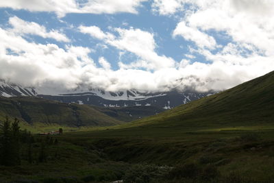 Scenic view of landscape against cloudy sky