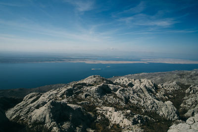 Scenic view of sea and mountains against sky