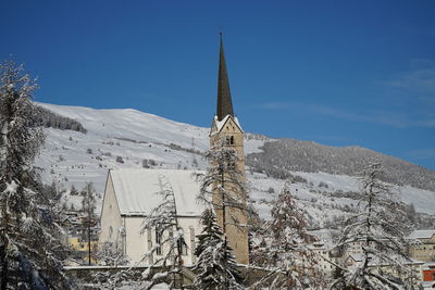 Snow covered buildings against sky