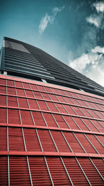 Low angle view of building against cloudy sky