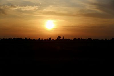 Scenic view of silhouette field against sky during sunset