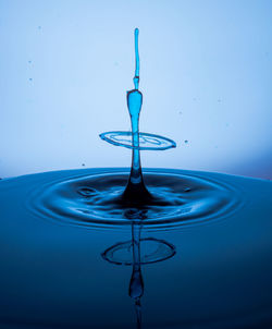 Close-up of water splashing against blue background