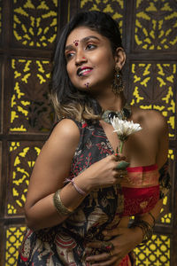 Portrait of beautiful young woman standing outdoors