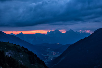 Scenic view of snowcapped mountains against sky at sunset