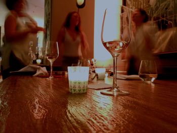 People drinking glass on table at restaurant