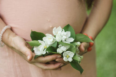 Close-up of hand holding flower bouquet