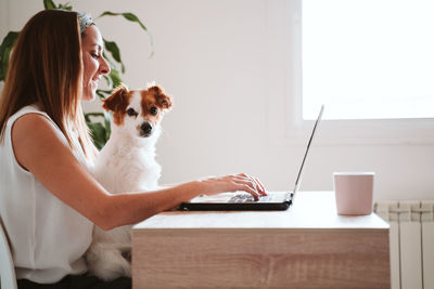 Dog and woman using smart phone